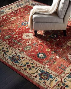 a chair sitting on top of a wooden floor next to a rug