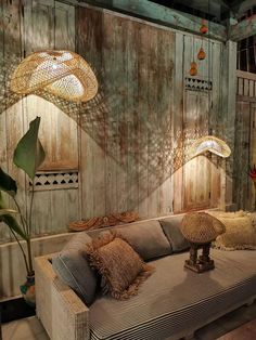 a living room filled with lots of furniture next to a wooden paneled wall and floor