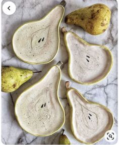 four pears and two bananas on a marble table