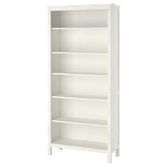 a white bookcase with four shelves on each side