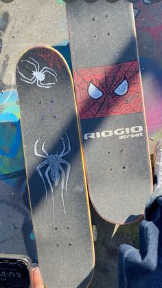 two skateboards with spider - man designs on them are shown in this aerial view