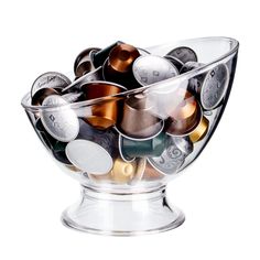 a glass bowl filled with lots of coins