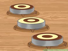 three metal trays sitting on top of a wooden table with circles in the middle