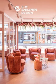 a living room filled with lots of pink furniture