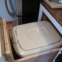 a white toilet sitting inside of a wooden box