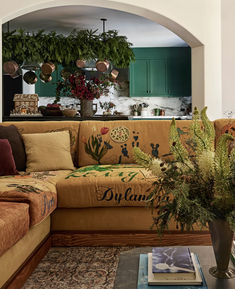 a living room filled with furniture and plants