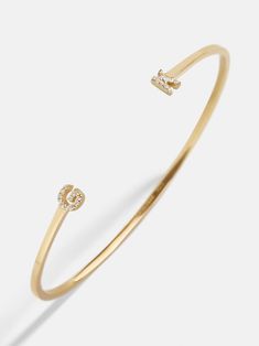 Our 18K Gold Double Initial Custom Cuff Bracelet is an updated take on a classic initial accessory. Available in an all-gold and a subtle sparkly version, these bracelets are ones you'll have for years to come. Add your own initials or that of you and a loved one to create a keepsake you'll cherish. Not to mention, this cuff bracelet is crafted with 18K gold plated sterling silver and Cubic Zirconia stones. Formal Gold Bracelets With Initials, Luxury Bracelets With Initials For Anniversary, Elegant Gold Bracelet With Initials, Elegant Yellow Gold Monogram Bracelets, Elegant Yellow Gold Monogram Bracelet, Luxury Gold Bracelets With Initials, Luxury Yellow Gold Name Bracelet With Initials, Custom Cuff Bracelet, Last Day To Order