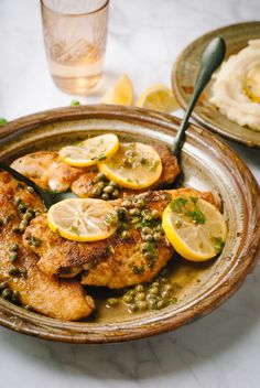 chicken with lemons and capers served on a plate