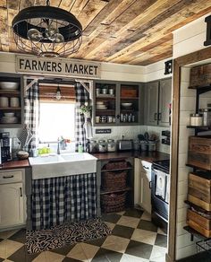 an old fashioned kitchen with black and white checkered flooring, wood paneled ceiling