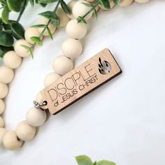 a wooden bead necklace with the word,'dope of jesus christ'on it