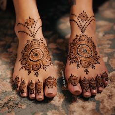 a woman's feet with hennap on it and the bottom part of her hands