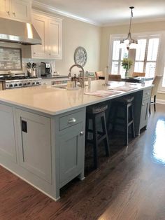 a large kitchen with an island in the middle