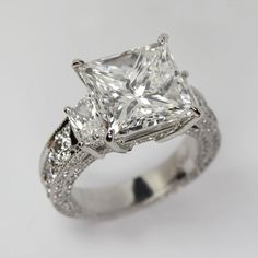 a princess cut diamond ring with pave set shoulders