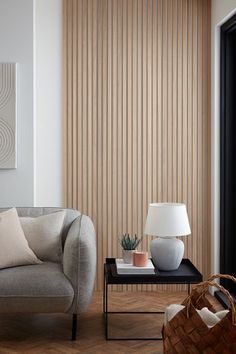 a living room scene with focus on the chair and table in front of the wall