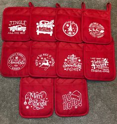 six red oven mitts with christmas designs on them sitting on the floor in front of a carpeted area