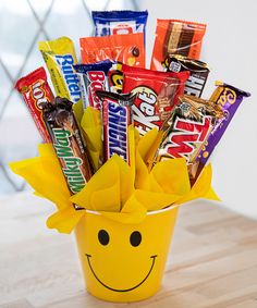 a yellow bucket filled with candy and candies