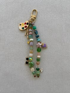 a keychain with beads and charms attached to it