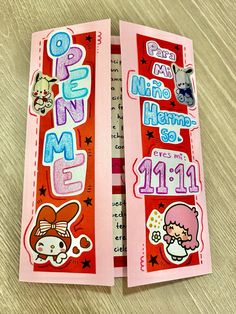 two pink bookmarks with stickers on them