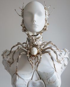 a white mannequin with an elaborate head piece