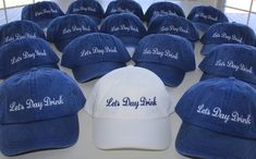 many blue and white hats sitting on top of a table with the words lee bay park written on them