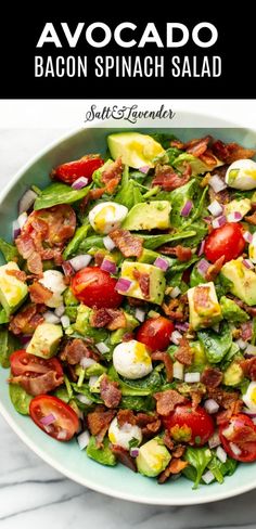 avocado bacon spinach salad in a white bowl