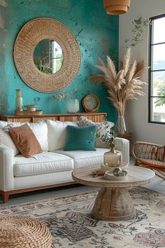 a living room filled with furniture and a round mirror on the wall above it's windows