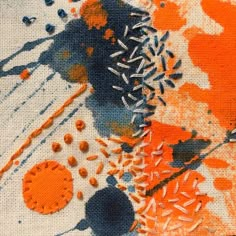 an orange and black painting with sprinkles on it's surface is shown