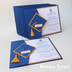 two blue and yellow graduation cards with tassels