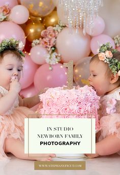 two babies are sitting in front of a cake