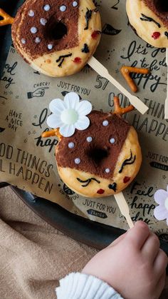 a tray with donuts decorated to look like mickey mouse ears and flowers on them