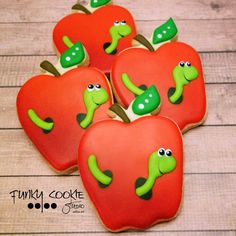 some cookies are shaped like apples with green eyes