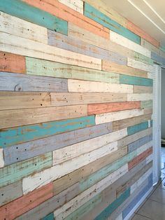 a wall made out of wooden planks in an office area with tile flooring