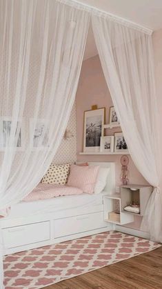 a bedroom with pink walls and white curtains