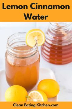 a mason jar filled with lemon water next to sliced lemons on a white plate