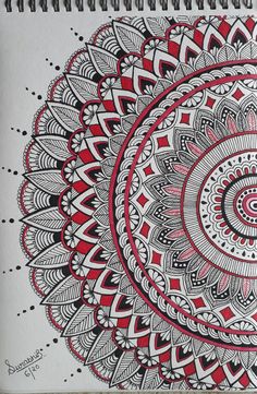 a spiral notebook with red and white designs on it