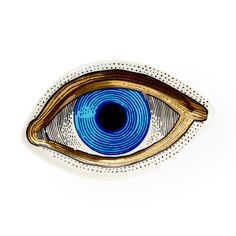 a blue eye is shown in the center of a white plate with dots on it