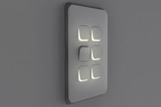 an illuminated light switch on the wall in a room with grey walls and flooring