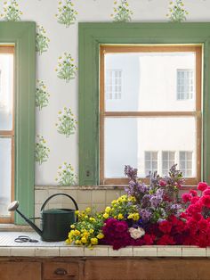 a window sill filled with lots of colorful flowers