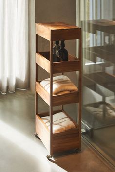 a wooden shelf with pillows and bottles on it