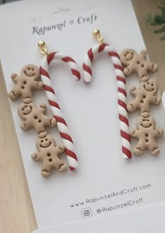 some candy canes and gingerbread cookies are on display in front of a card