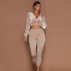 A little casual a lot of sexy... this jogger pant set has it all. Featuring a cropped zippered jacket with elastic trim and fitted jogger pants with an elastic waist in soft & comfy velvet finish. Made with a cotton blend and comes in three fabulous colors from which to choose. Velvet Joggers Outfit, Joggers Outfit Casual, Blazer E Short, Suede Suit, Crop Top Pants Set, Velvet Tracksuit, Velvet Joggers, Velvet Set, Joggers Outfit