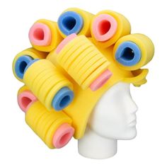 a white mannequin head with yellow and blue hair pieces on top of it