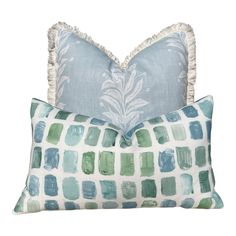 two pillows with blue and green designs on them