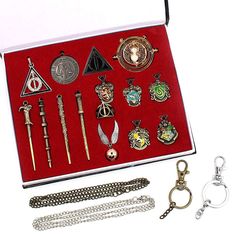 an open box with various items in it on a white surface, including a chain and keychain