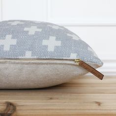 a close up of a pillow on a wooden surface