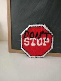 a don't stop sign made out of felt