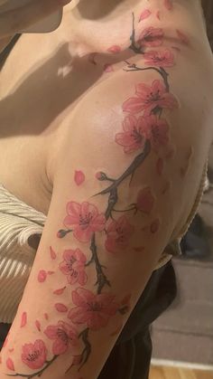 a woman's arm with pink flowers on it