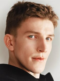 a close up of a person wearing a bow tie and looking at the camera with a serious look on his face