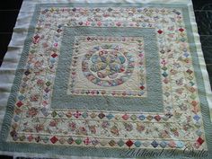 a quilted table runner with an intricate design