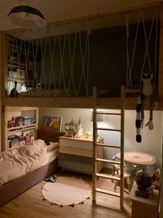 a bedroom with a loft bed, desk and shelves